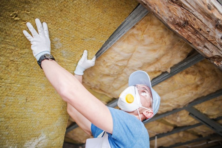 man working on insulation in home